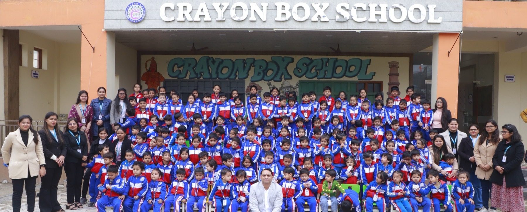 Crayon Box School complete student body and faculty gathered in front of the school building